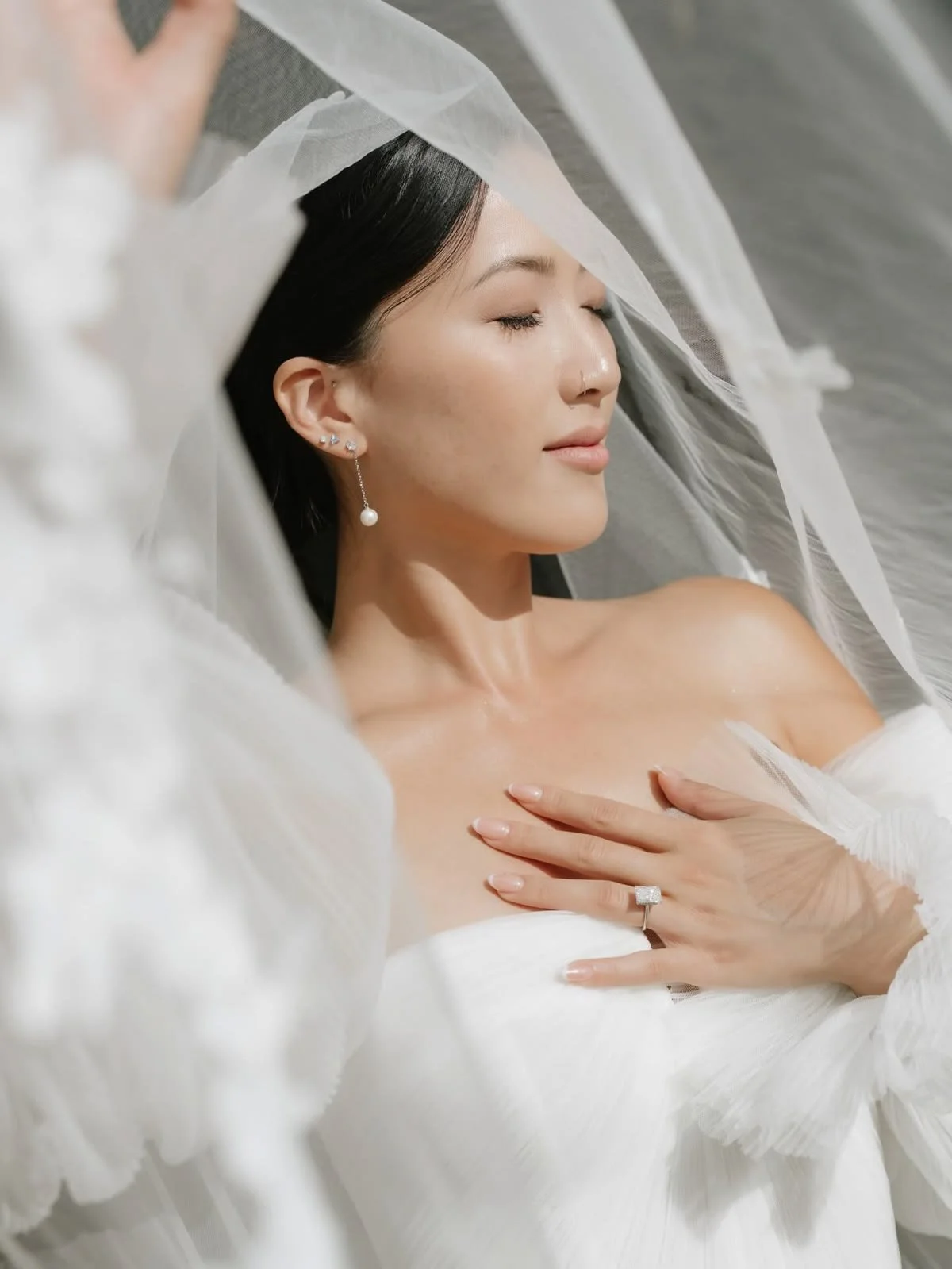 A bride with her veil lifting in the breeze